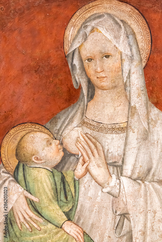 Religious medieval italian fresco showing Mary breast feeding baby Jesus © Giorgio G