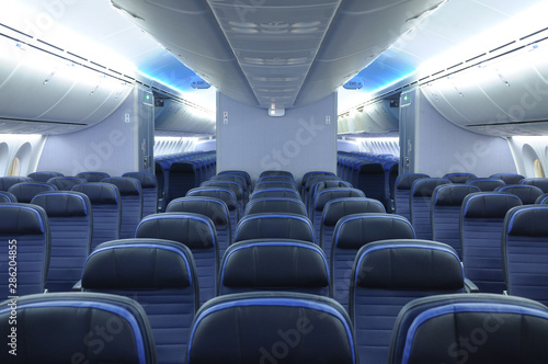 Empty 787 commercial airplane cabin interior with blue leather seats