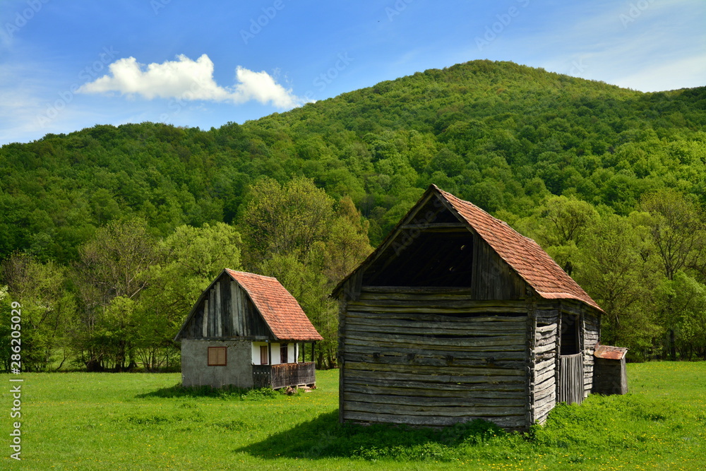 an old house on a green field an old house on a green field