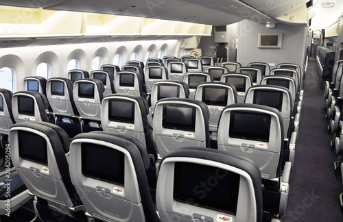 Commercial airplane seats with inflight entertainment displays/screens viewed from the rear