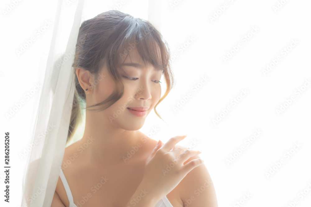 Portrait of beautiful young asian woman makeup of cosmetic, girl hand touch shoulder and smile attractive, face of beauty perfect with wellness in the bedroom with skin care and healthcare concept. Portrait of beautiful young asian woman makeup of cosmetic, girl hand touch shoulder and smile attractive, face of beauty perfect with wellness in the bedroom with skin care and healthcare concept.