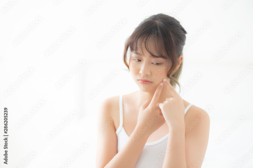 Beautiful portrait young asian woman with acne problem in the bedroom, trouble of beauty on face, zit treatment, asia girl is pimple having worry and displeased, skincare and healthy concept. Beautiful portrait young asian woman with acne problem in the bedroom, trouble of beauty on face, zit treatment, asia girl is pimple having worry and displeased, skincare and healthy concept.