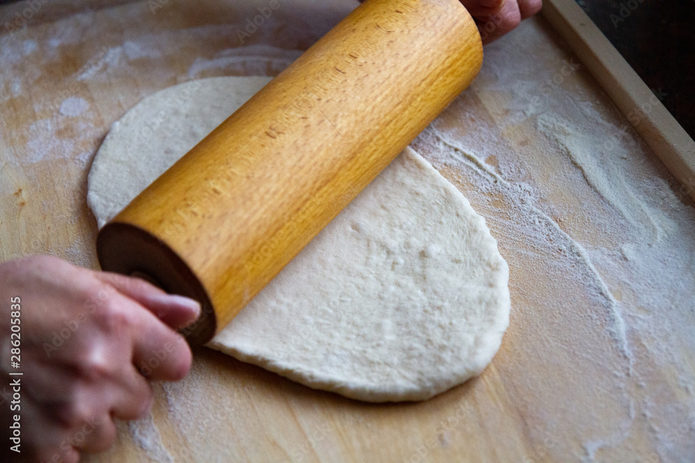 preparation of a dough for baking on a chopping board - preparing Slovakian steamed buns preparation of a dough for baking on a chopping board - preparing Slovakian steamed buns