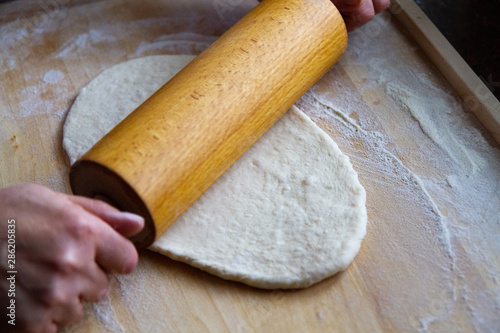 preparation of a dough for baking on a chopping board - preparing Slovakian steamed buns