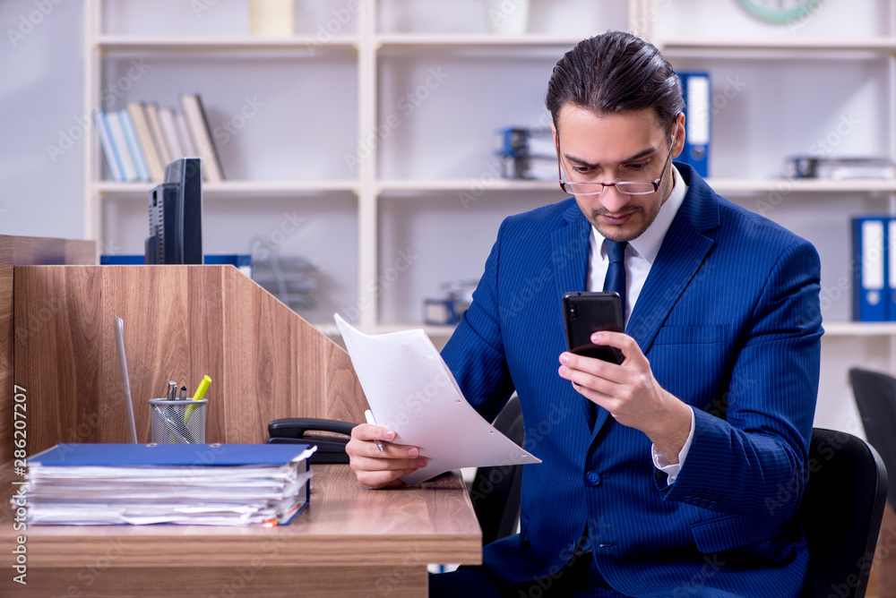 Young handsome businessman working in the office Young handsome businessman working in the office