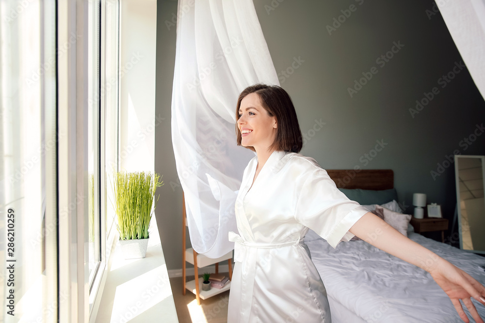 Morning of beautiful young woman near window Morning of beautiful young woman near window