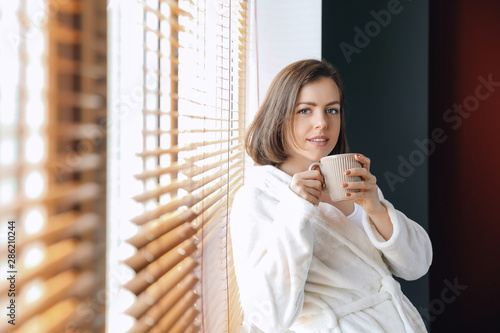 Beautiful young woman drink...