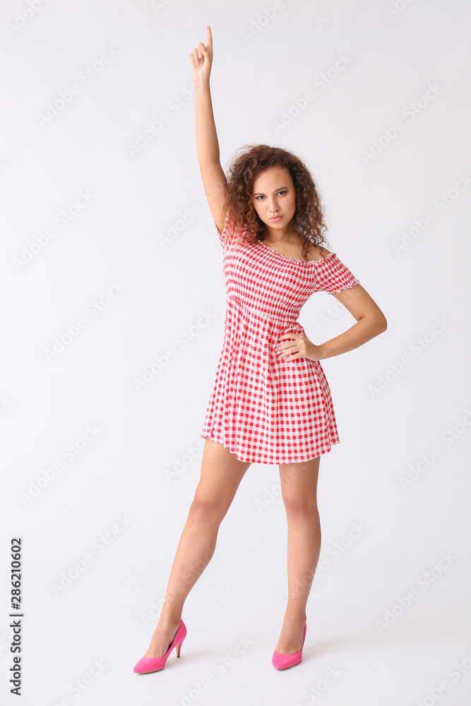 Beautiful African-American woman posing against white background Beautiful African-American woman posing against white background