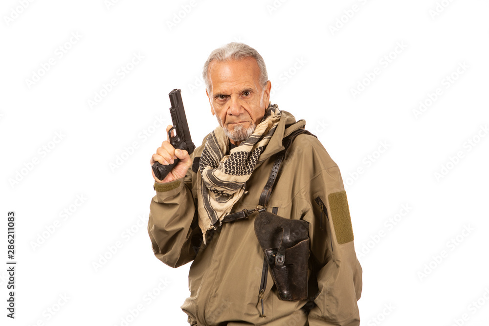 Gun drawn, mature survivalist wearing a shemagh. Gun drawn, mature survivalist wearing a shemagh.
