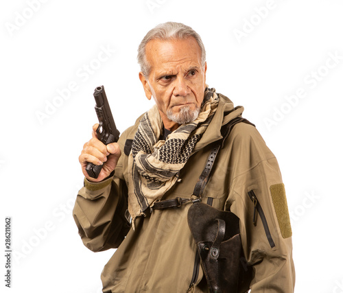 Принти на полотні Serious doomsday prepper with gun drawn, looking off camera on a white background