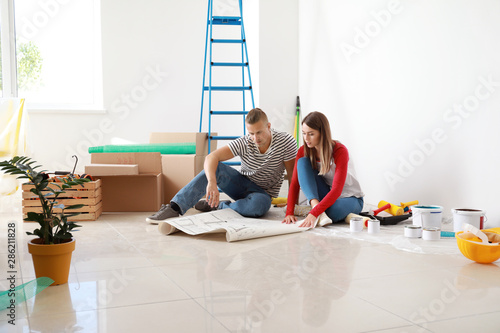 Happy young couple planning...