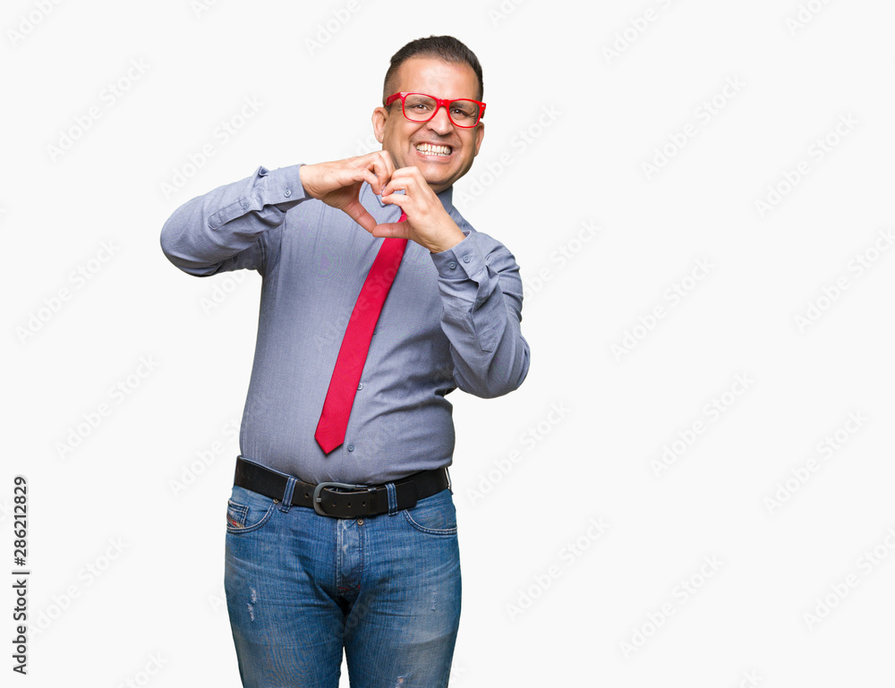 Middle age arab man wearing fashion red glasses over isolated background smiling in love showing heart symbol and shape with hands. Romantic concept. Middle age arab man wearing fashion red glasses over isolated background smiling in love showing heart symbol and shape with hands. Romantic concept.