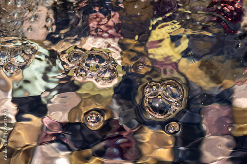 Fototapeta Naklejka Na Ścianę i Meble -  Water bubbles and ripples on a fountain, close-up