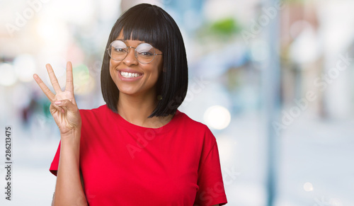 Beautiful young african american woman wearing glasses over isolated background showing and pointing up with fingers number three while smiling confident and happy.
