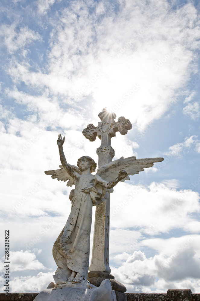 statue of angel with blue sky