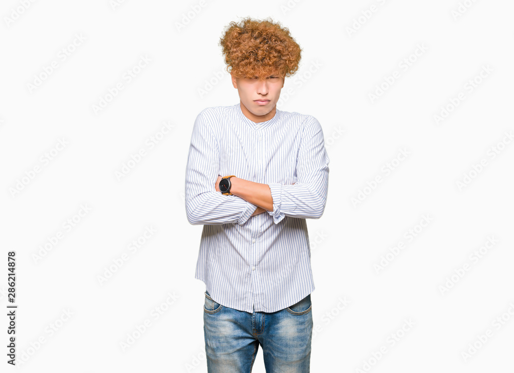 Young handsome business man with afro hair wearing elegant shirt skeptic and nervous, disapproving expression on face with crossed arms. Negative person. Young handsome business man with afro hair wearing elegant shirt skeptic and nervous, disapproving expression on face with crossed arms. Negative person.