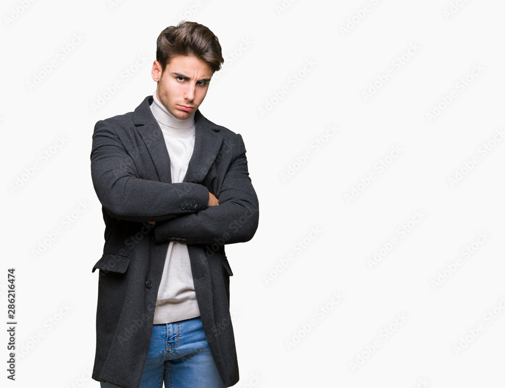 Young elegant man wearing winter coat over isolated background skeptic and nervous, disapproving expression on face with crossed arms. Negative person. Young elegant man wearing winter coat over isolated background skeptic and nervous, disapproving expression on face with crossed arms. Negative person.