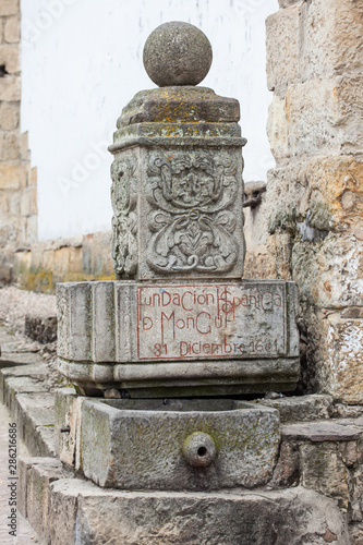 Stone fountain in which you can read the date of the founding of Mongui photo