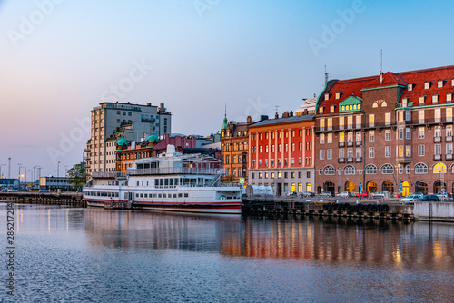 Sunset view of waterfront alongside a channel in Malmo, Sweden photo