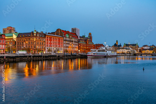 Sunset view of waterfront alongside a channel in Malmo, Sweden photo