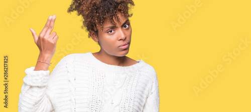 Obraz na plátne Beautiful young african american woman wearing winter sweater over isolated background Shooting and killing oneself pointing hand and fingers to head, suicide gesture