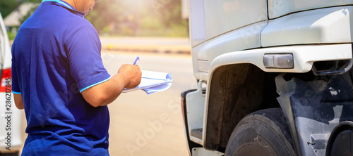 Truck drivers hand holding clipboard Check the product list,Preforming a pre-trip inspection on a truck,spot focus.