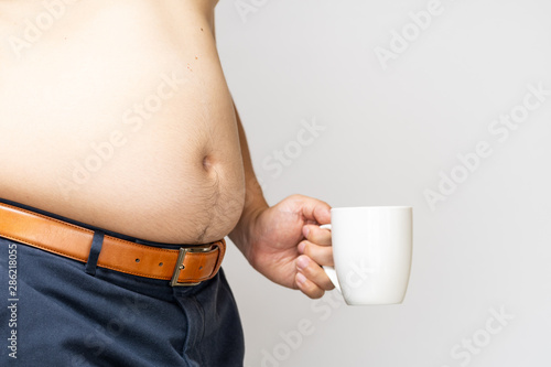 belly of a Japanese fat man holding a white cup