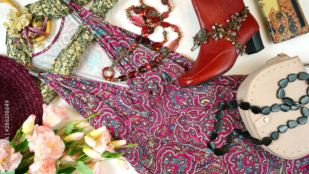 On-trend Boho Chic style fashion layout flat lay with red pink floral summer dress and accessories.