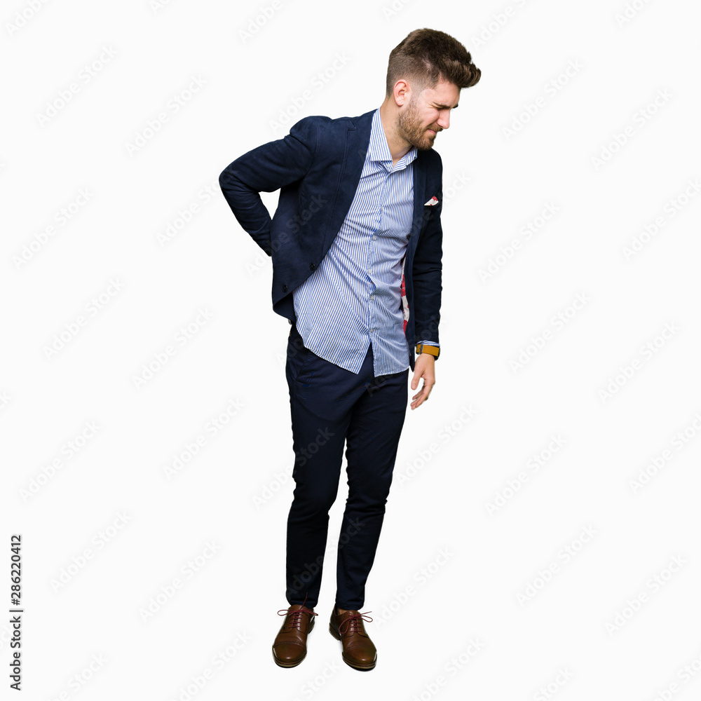 Young handsome bussines man Suffering of backache, touching back with hand, muscular pain Young handsome bussines man Suffering of backache, touching back with hand, muscular pain