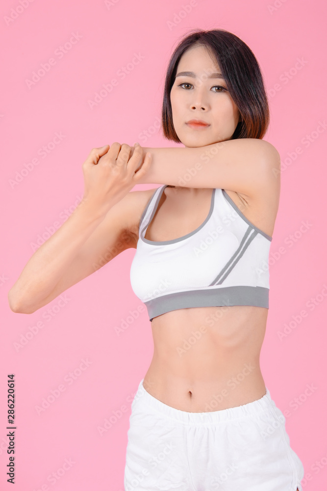 sport woman standing warm-up and stretch body before doing exercise on pink backgrounds, fitness concept, sport concept sport woman standing warm-up and stretch body before doing exercise on pink backgrounds, fitness concept, sport concept