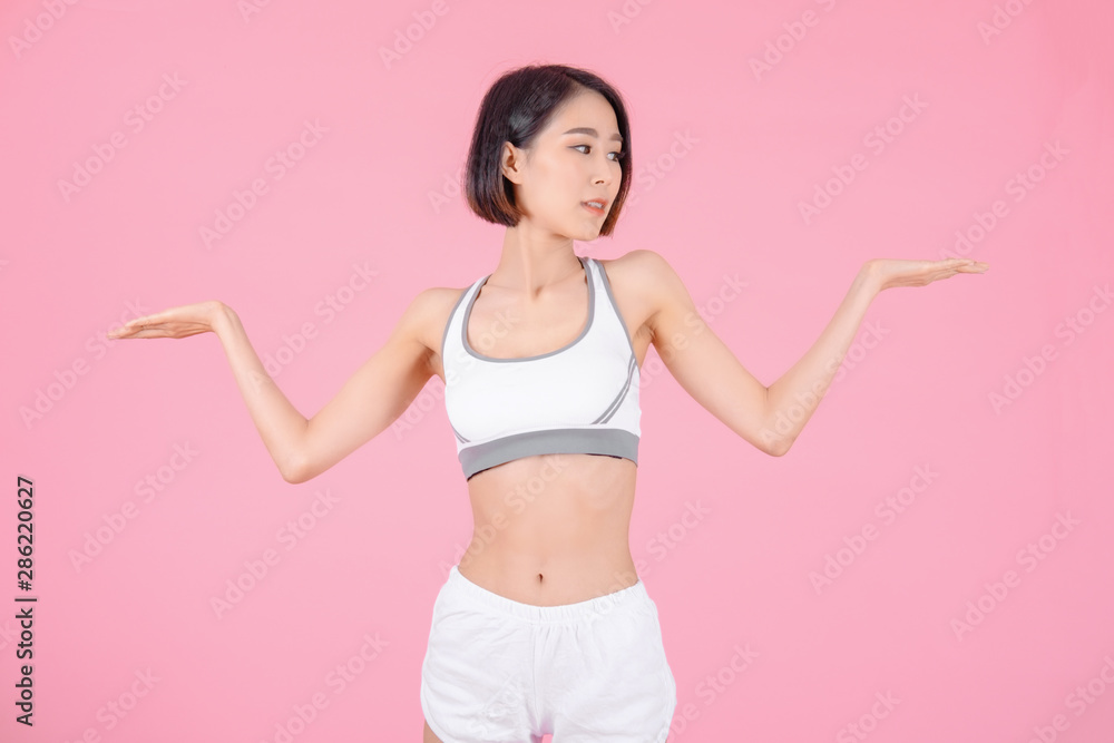 sport woman standing open hands and showing muscle bodybuilding on pink backgrounds, fitness concept, sport concept sport woman standing open hands and showing muscle bodybuilding on pink backgrounds, fitness concept, sport concept