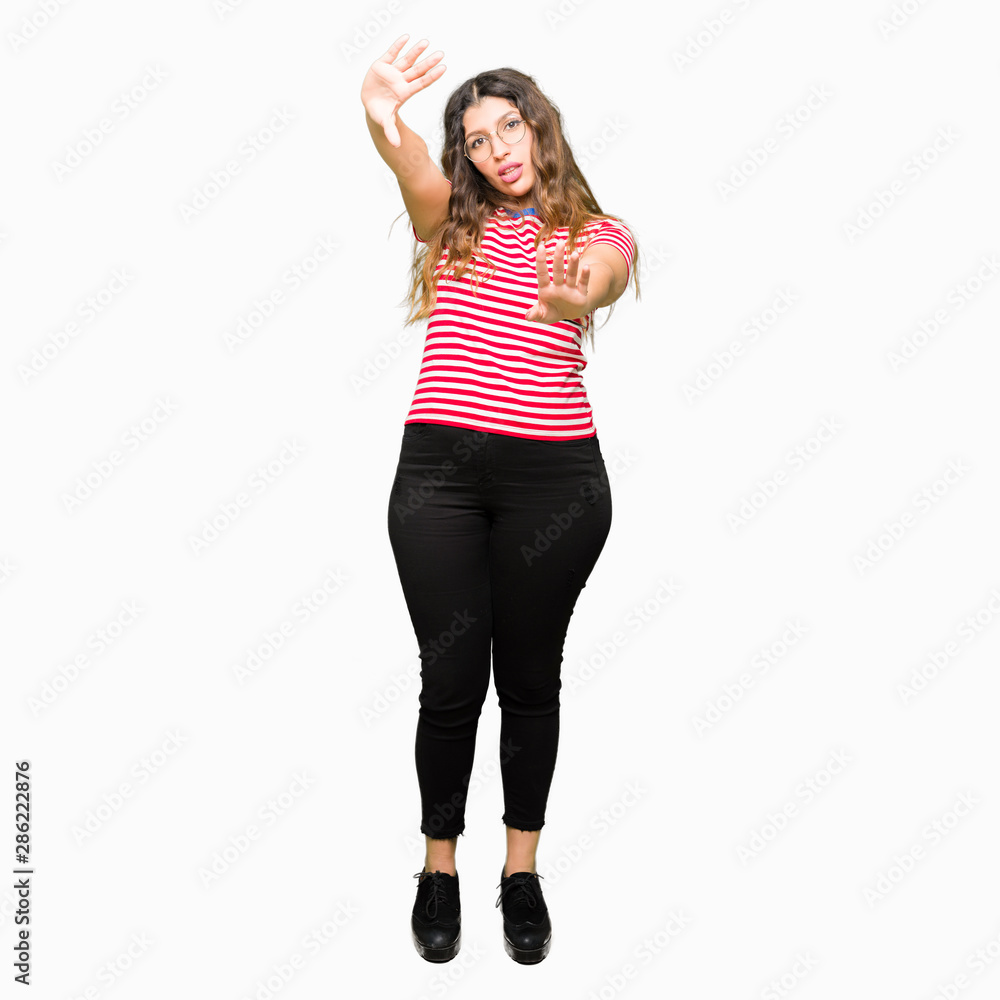 Young beautiful woman wearing glasses Smiling doing frame using hands palms and fingers, camera perspective Young beautiful woman wearing glasses Smiling doing frame using hands palms and fingers, camera perspective