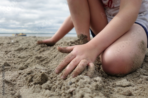 Child playing on a sandy beach