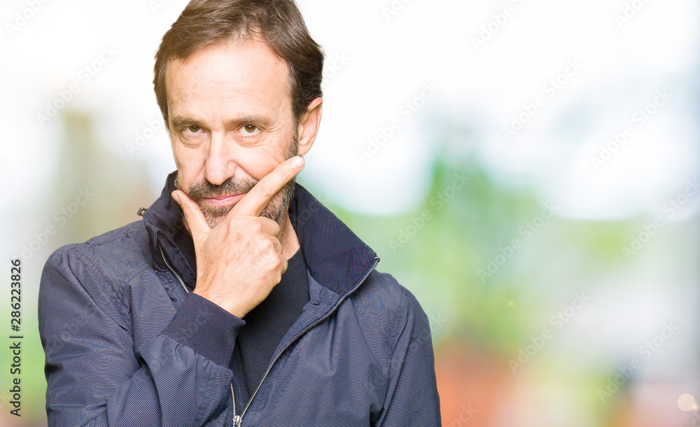 Middle age handsome man wearing a jacket looking confident at the camera with smile with crossed arms and hand raised on chin. Thinking positive. Middle age handsome man wearing a jacket looking confident at the camera with smile with crossed arms and hand raised on chin. Thinking positive.