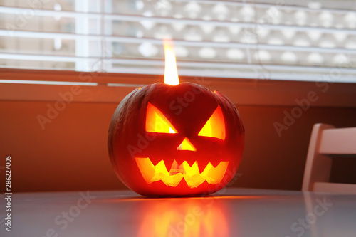 Wallpaper Mural Halloween October holiday celebration symbol, scary pumpkin on kitchen table glowing from inside Torontodigital.ca