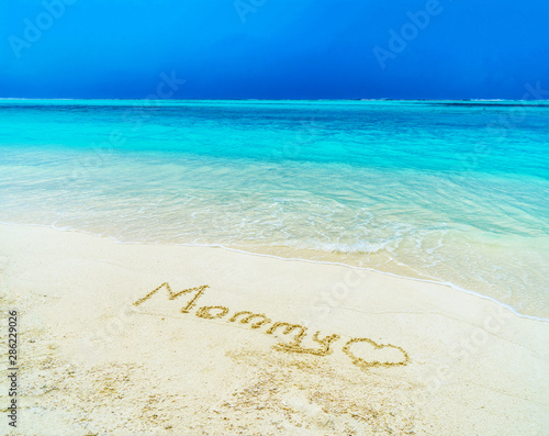 Beautiful sunny beach by the blue sea. Inscription