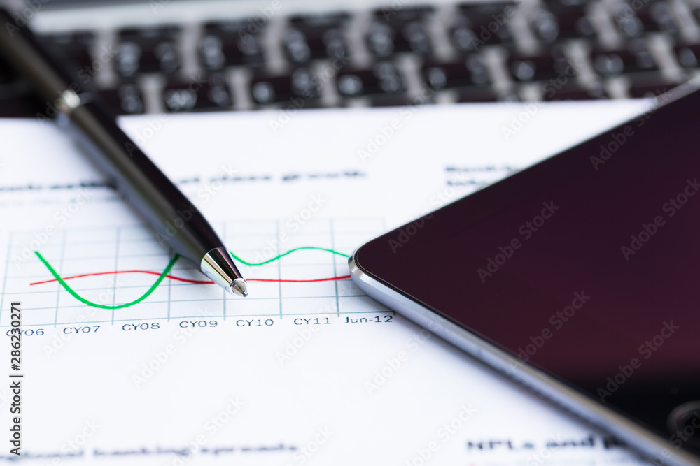 Close up of pen with financial graphs, Business concept. Close up of pen with financial graphs, Business concept.