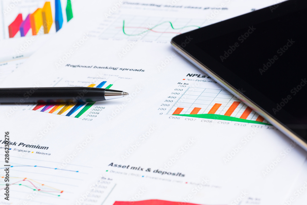Close up of pen with financial graphs, Business concept. Close up of pen with financial graphs, Business concept.
