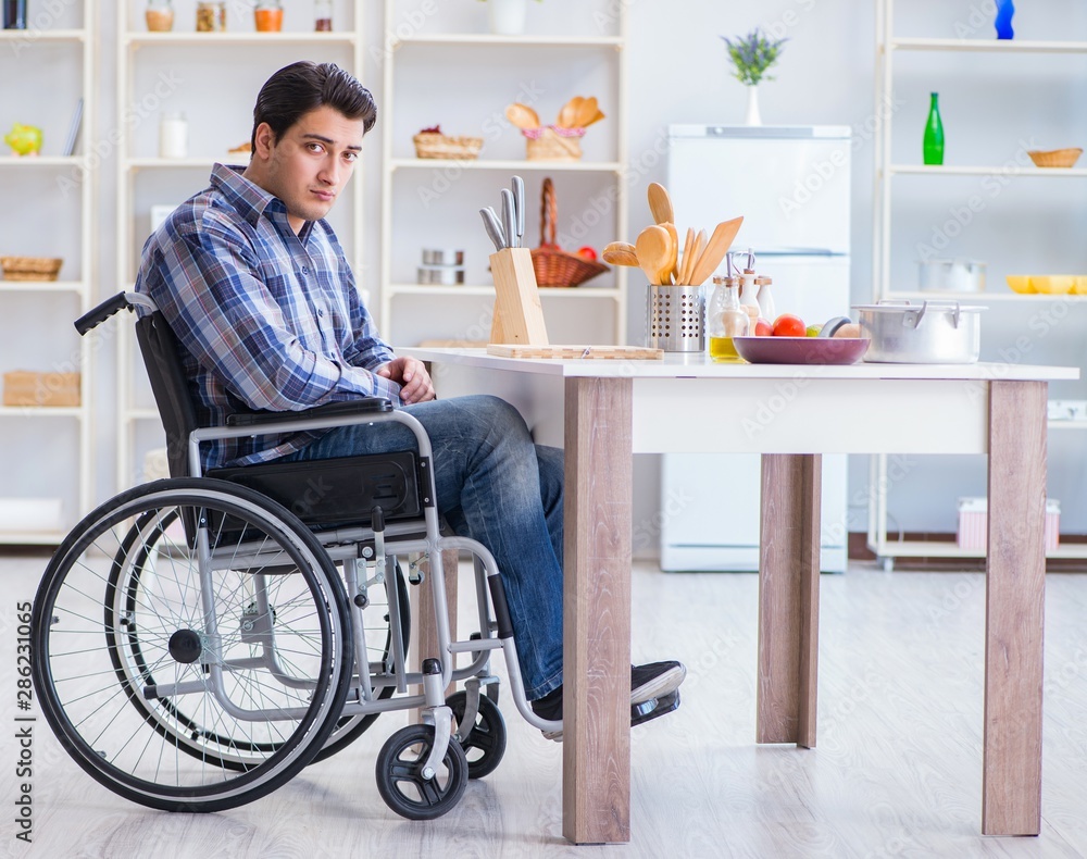 Disabled young man husband working in kitchen Disabled young man husband working in kitchen