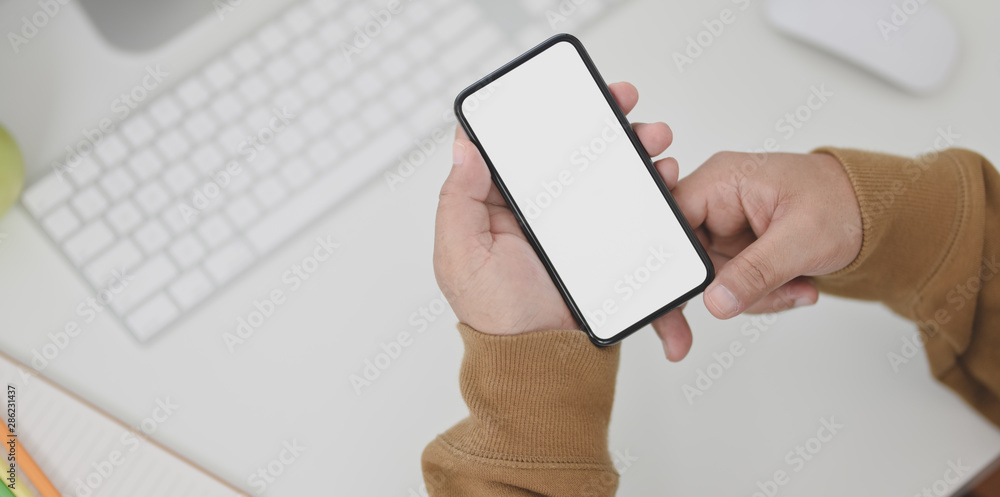 Close-up view of man hands holding blank screen smartphone Close-up view of man hands holding blank screen smartphone