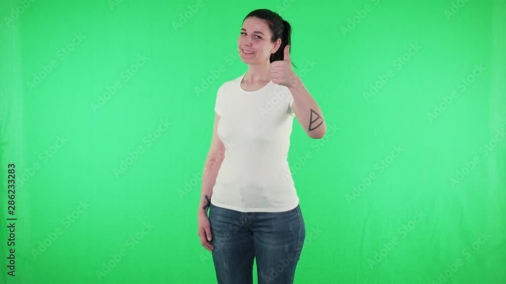 Cheerful woman in white t-shirt show thumbs up gesture green screen background Cheerful woman in white t-shirt show thumbs up gesture green screen background