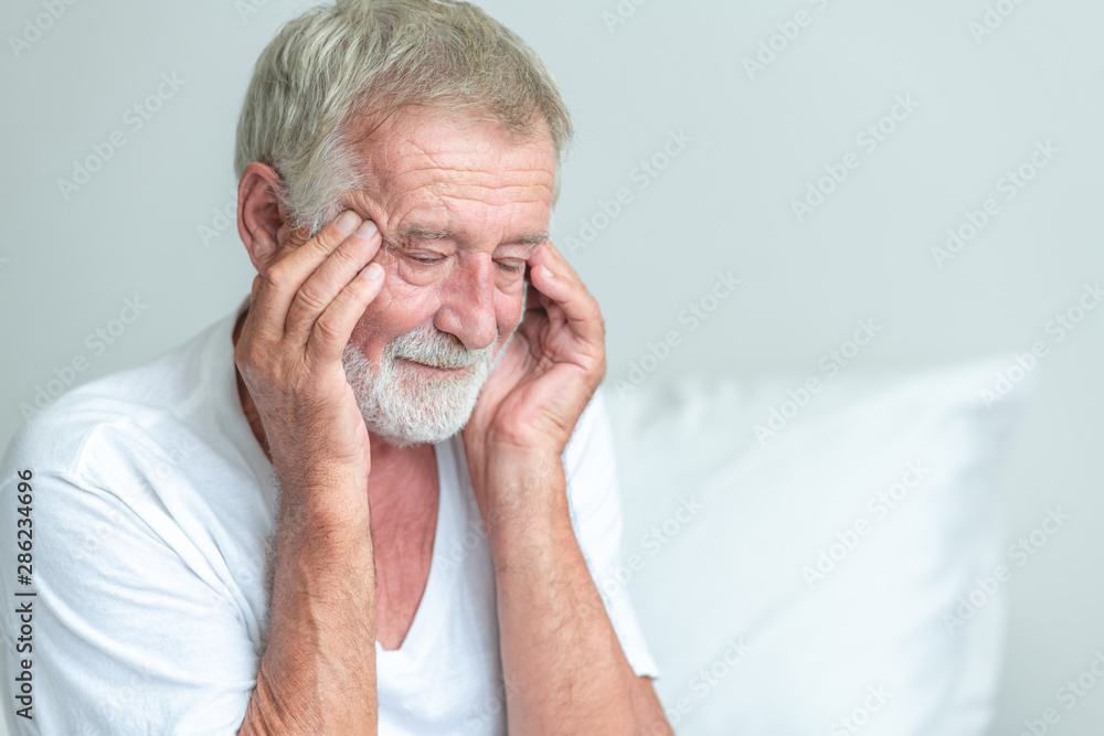 Senior man sitting in bed, try to remember the past. Senior man sitting in bed, try to remember the past.