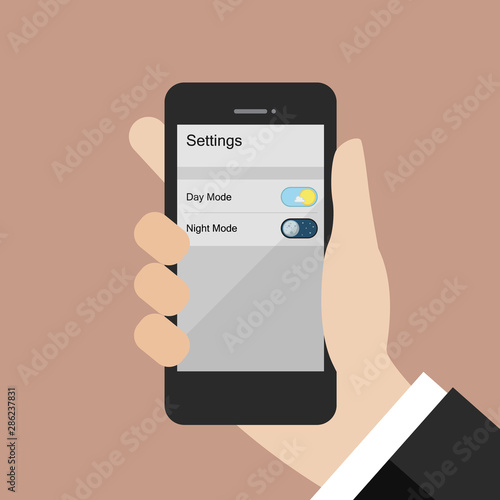Hand choosing day mode or night mode in smartphone