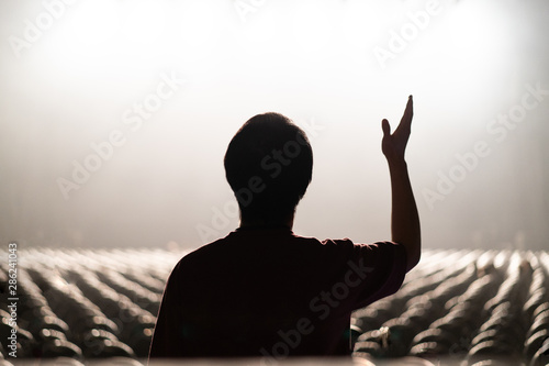 a man worships God alone in the concert hall with a smoke effect. photo