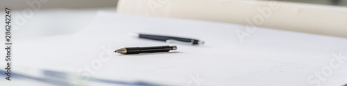 Wide view image of pencil lying on a project draft