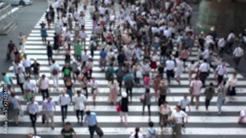 Wallpaper Mural UMEDA, OSAKA, JAPAN - CIRCA JULY 2019 : Aerial blurred view of zebra crossing near Osaka train station. Crowd of people at the street. Shot in busy rush hour. Slow motion. Torontodigital.ca