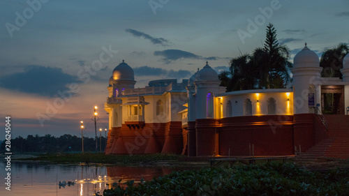 Beautiful light effect after sunset at red and white lake Palace with beautiful domes, arches and balconets, Tripura, India, Asia