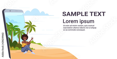 woman using cellphone african american girl relaxing on tropical island sea beach summer vacation concept smartphone screen online mobile app flat full length horizontal copy space