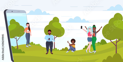 people using cellphones mix race men women walking outdoor having fun digital technology addiction concept smartphone screen mobile app flat full length horizontal