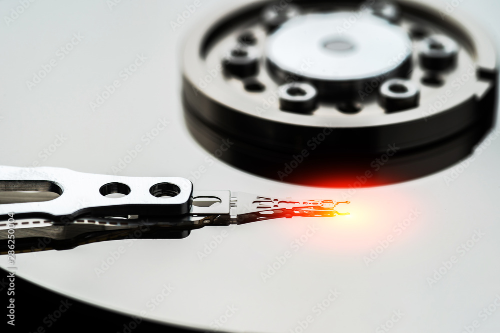 Closeup macro photo of head in opened hard disk drive. Concept of repair or recovery information from broken HDD. Closeup macro photo of head in opened hard disk drive. Concept of repair or recovery information from broken HDD.